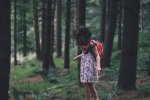 child-in-woods-with-backpack