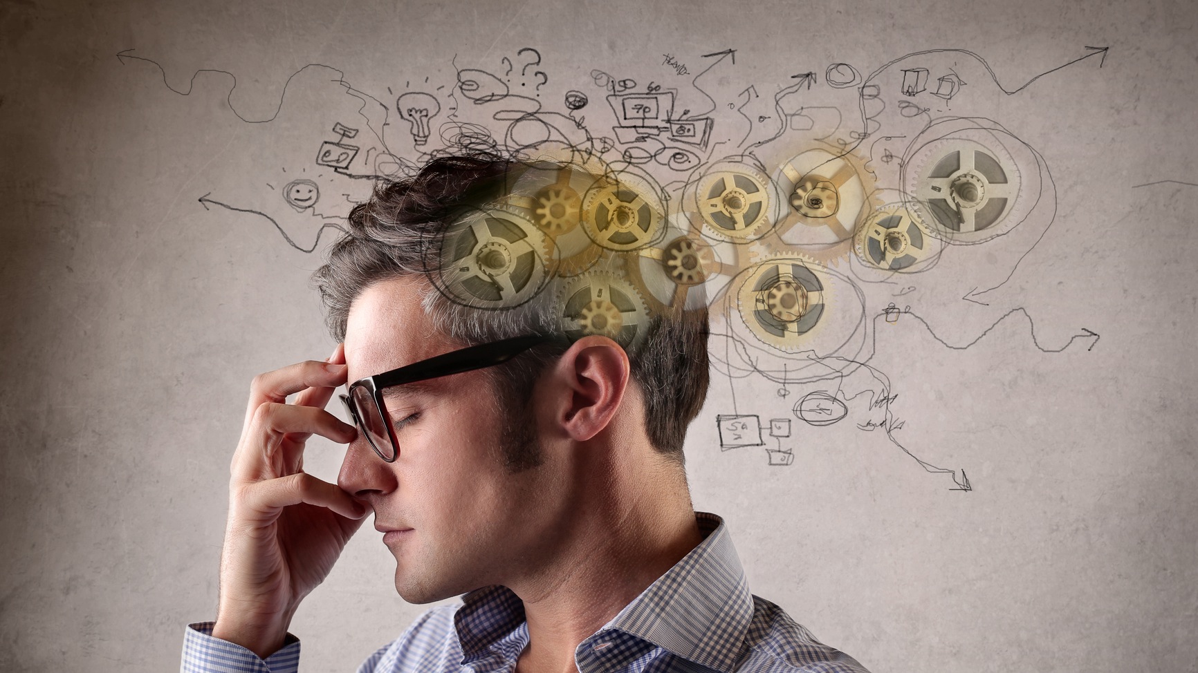 Stressed man witht hand on face and cartoon-like scribbles of gears and frustration marks around his head