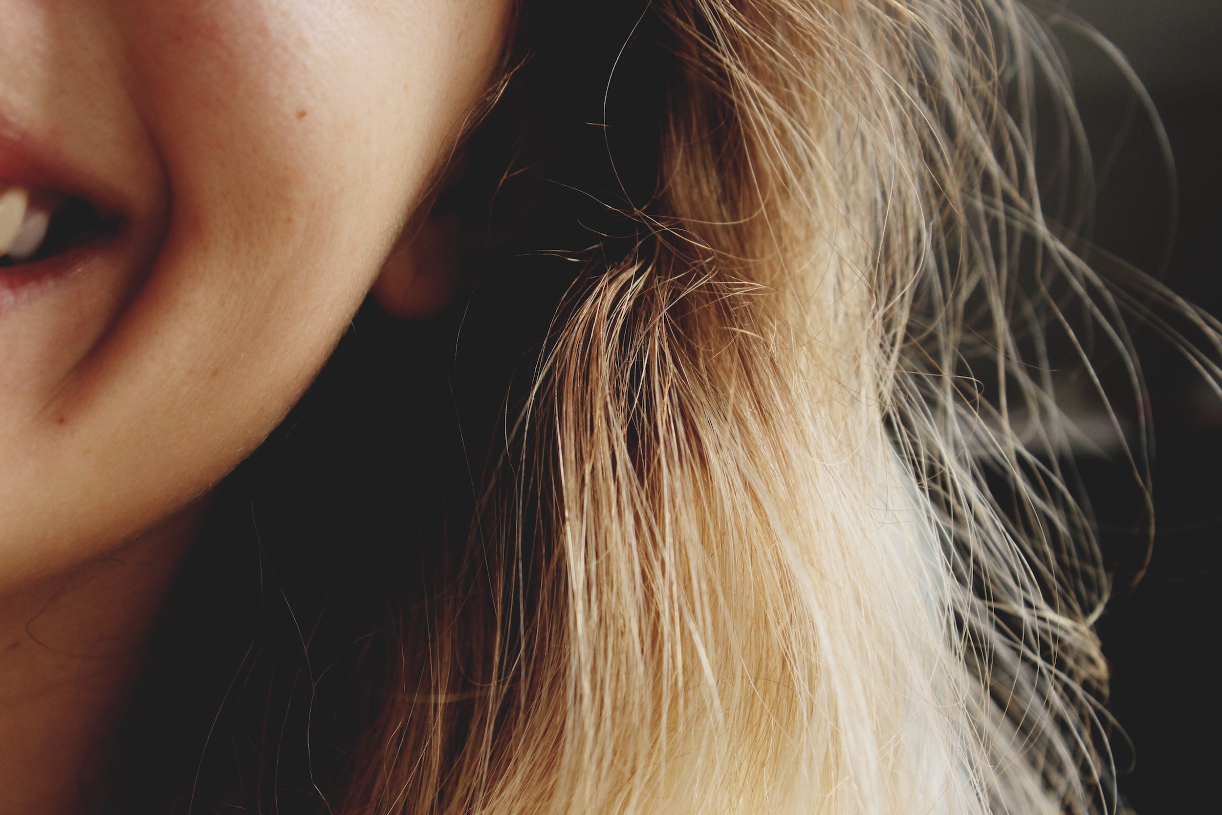 Girl with the left side of her mouth turned up in a smile.