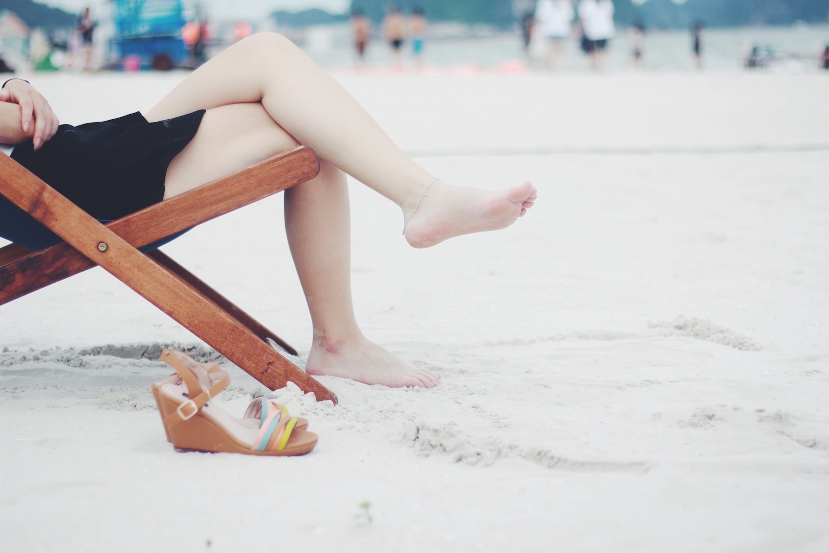 Woman sitting on beach meditating