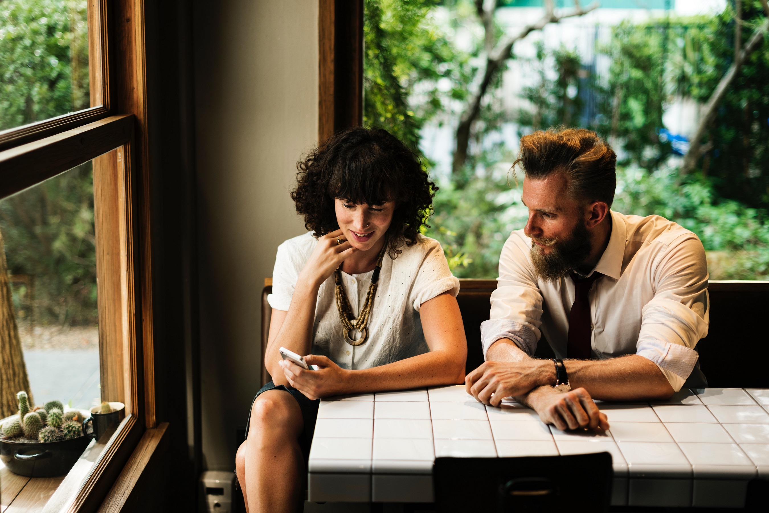 Man and woman looking at something together on a phone.