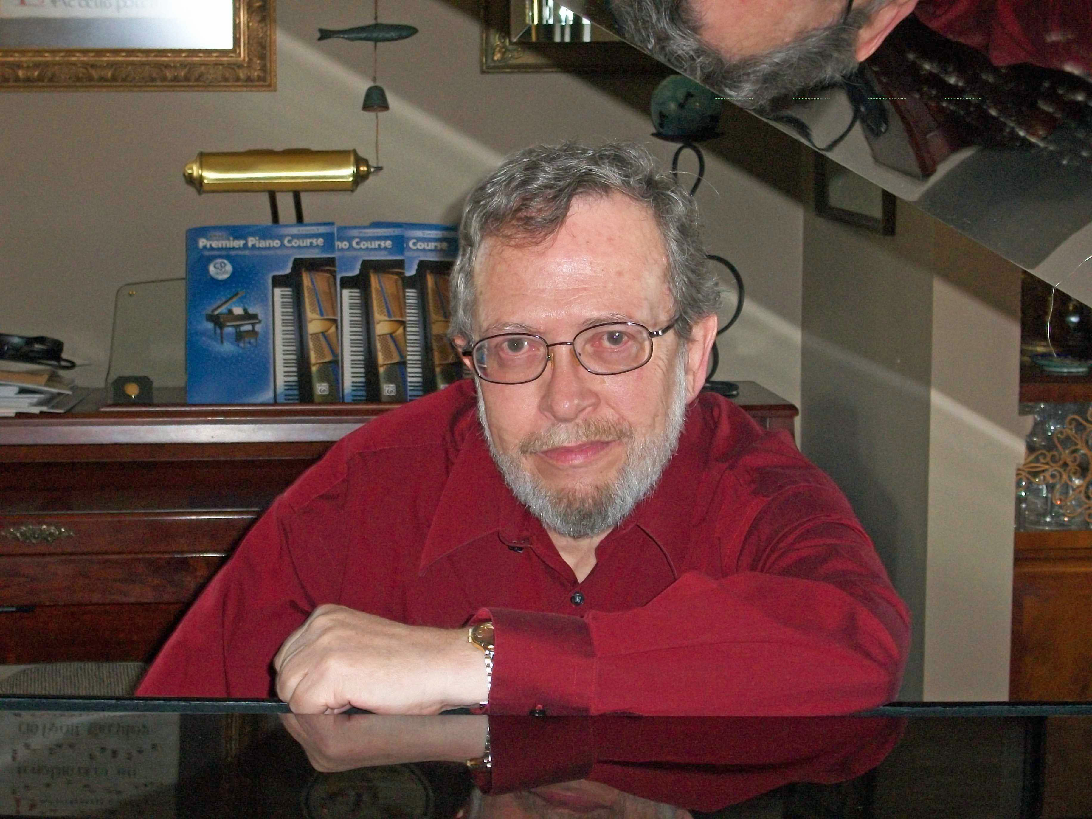 Grover Farr, music teacher sitting at piano