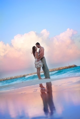 Couple embracing on beach in sunset