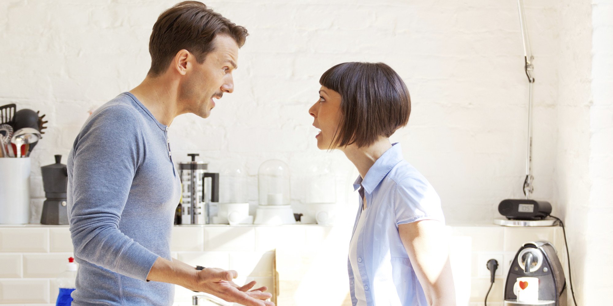 Couple arguing in a kitchen