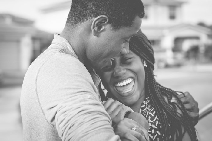 African American man hugging a laughing woman